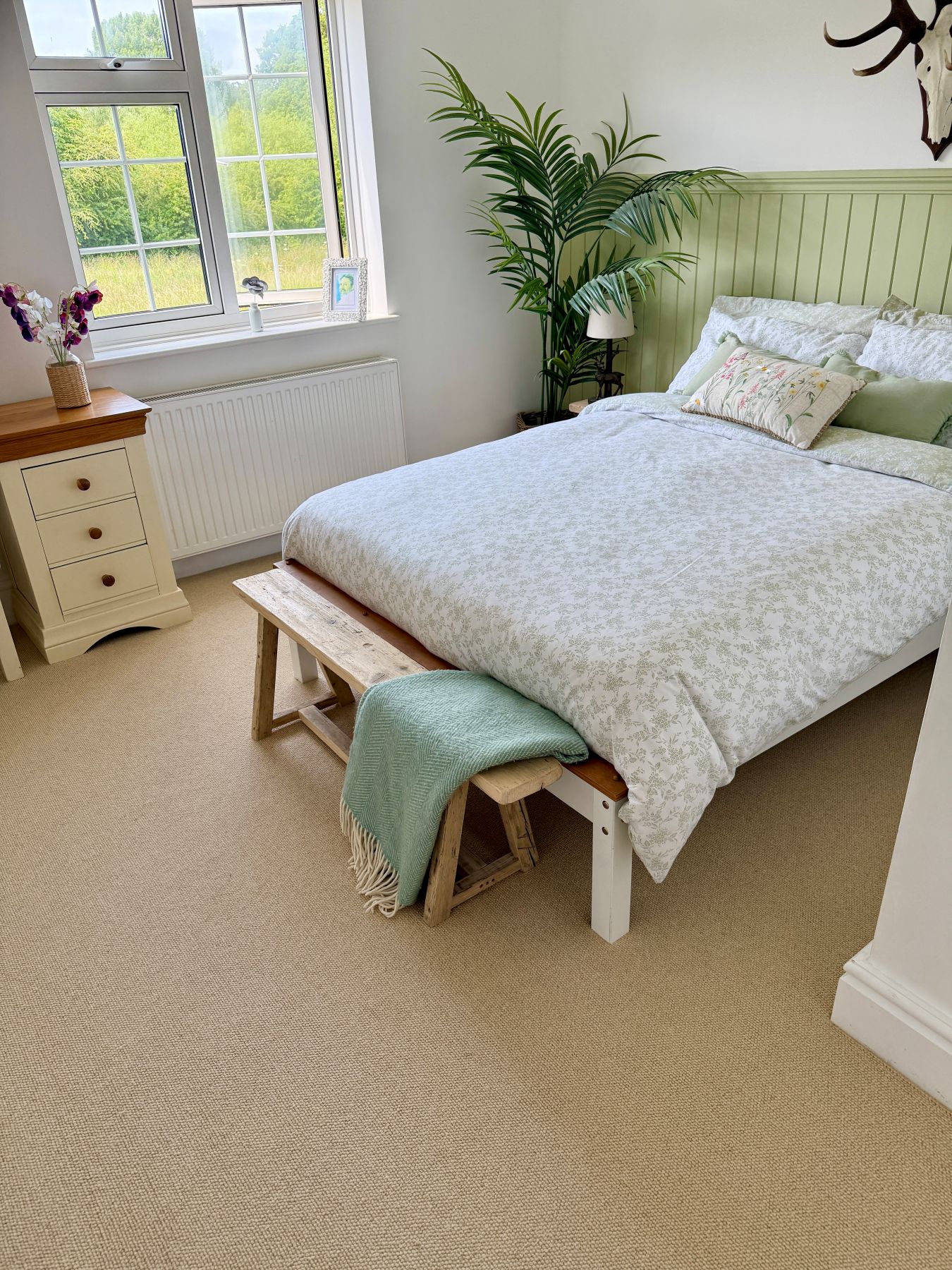 cream cobble loop pile carpet in country bedroom with green panelling